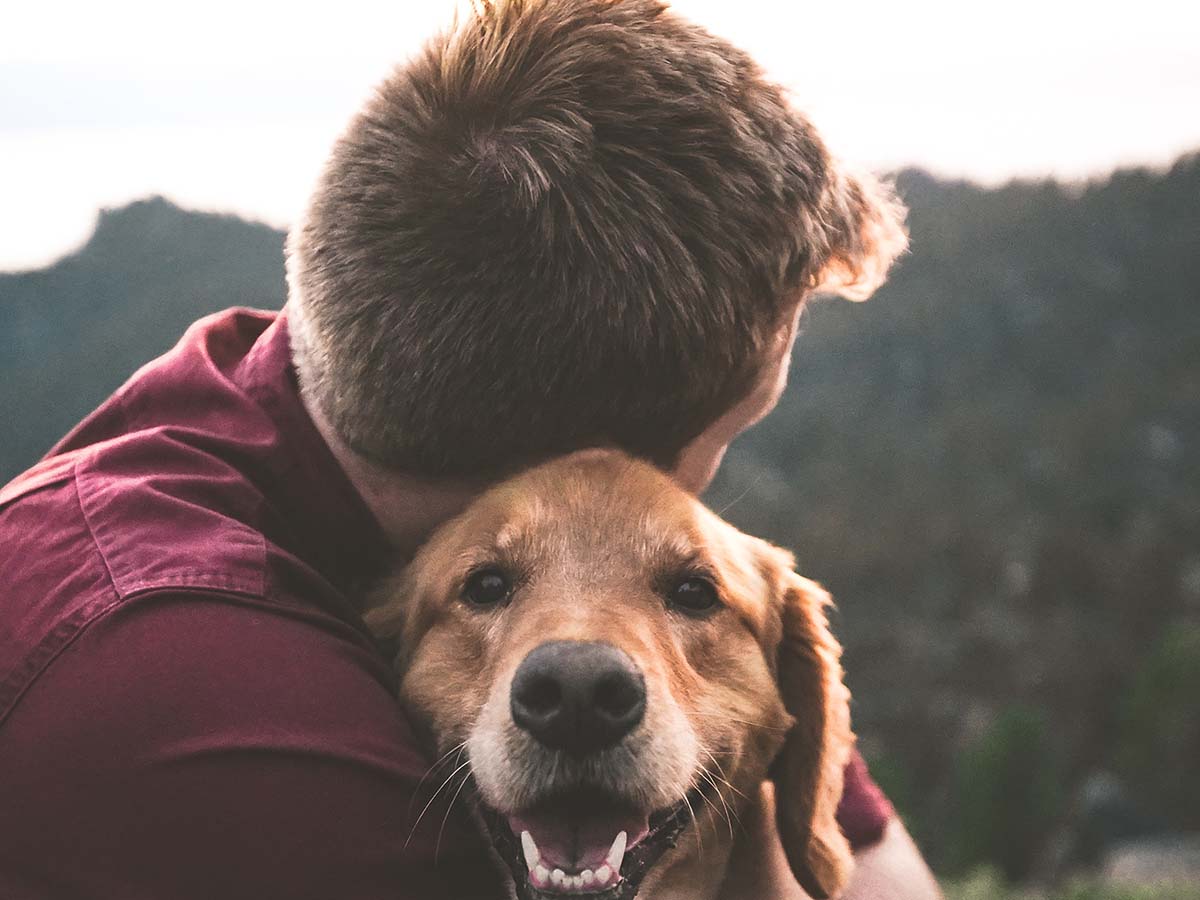 A man holding his dog
