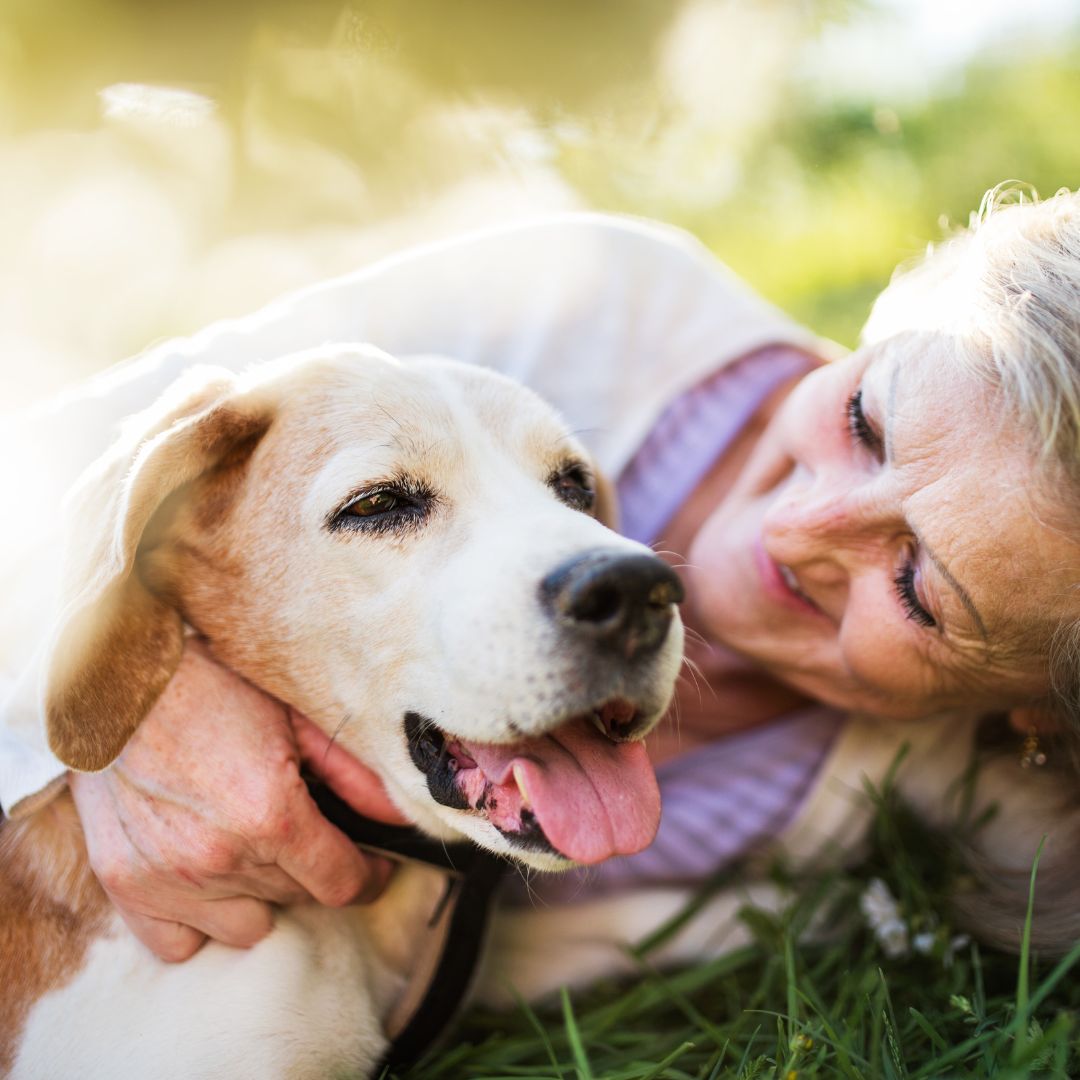 Happy senior woman hugging her dog